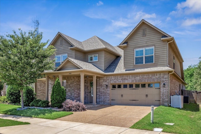 1668 Jennings Mill Ln, Collierville, TN 38017 - view of front of property with brick siding, concrete driveway, a garage, central AC, and roof with shingles