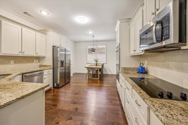 1668 Jennings Mill Ln, Collierville, TN 38017 - kitchen featuring appliances with stainless steel finishes, crown molding, backsplash, white cabinets, and light stone counters