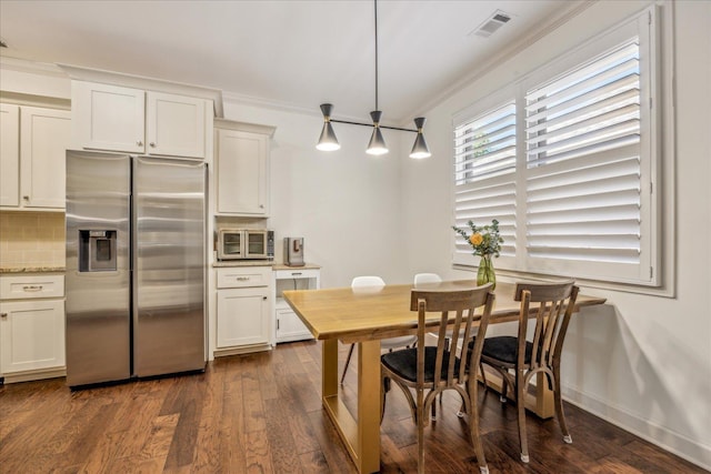 1668 Jennings Mill Ln, Collierville, TN 38017 - kitchen featuring stainless steel refrigerator with ice dispenser, tasteful backsplash, ornamental molding, dark wood-type flooring, and white cabinets