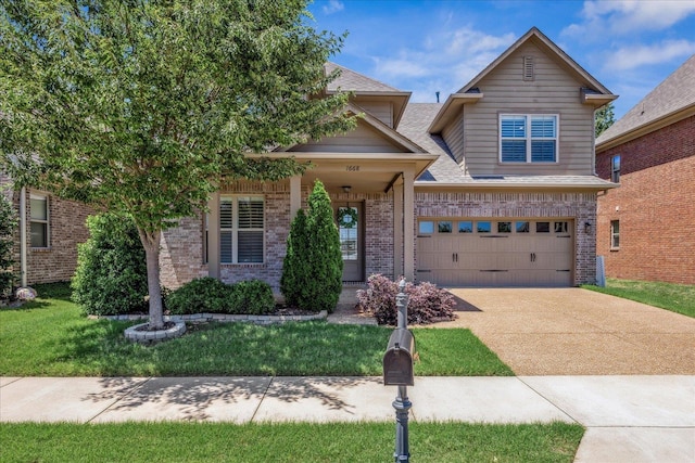 1668 Jennings Mill Ln, Collierville, TN 38017 - view of front of home featuring brick siding, driveway, a garage, and a front lawn