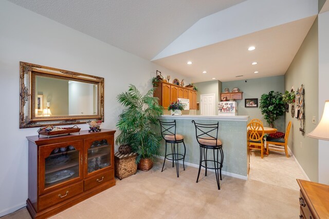 1800 Appling Oaks Cir Unit 75, Cordova, TN 38016 - kitchen featuring refrigerator, light carpet, a breakfast bar, recessed lighting, and vaulted ceiling