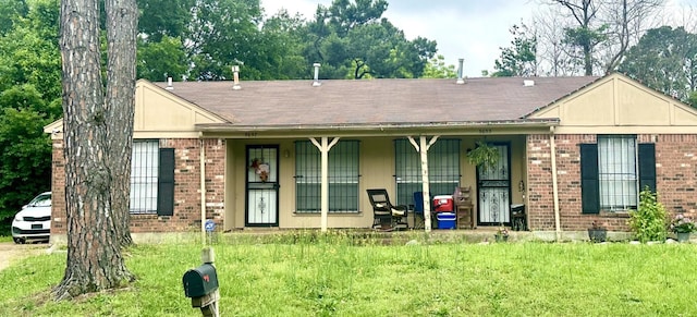 5655 Myers Rd, Memphis, TN 38115 - view of front of property featuring brick siding, covered porch, a front yard, and a shingled roof