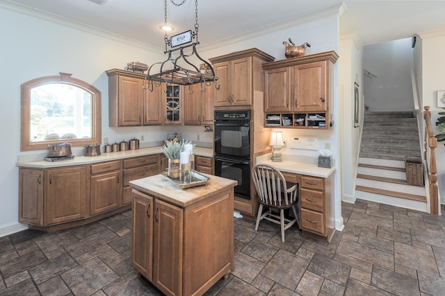 1245 Auburn Woods Dr, Collierville, TN 38017 - kitchen featuring crown molding, brown cabinets, stone tile floors, glass insert cabinets, and baseboards