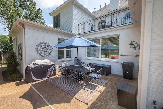 1245 Auburn Woods Dr, Collierville, TN 38017 - back of property featuring a balcony, a patio, brick siding, and outdoor dining space