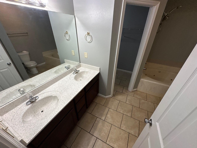 4136 Hampton Manor Ln, Memphis, TN 38128 - full bathroom featuring a tub with jets, tile patterned floors, double vanity, toilet, and a walk in closet