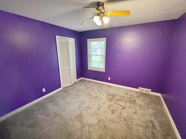 3751 Lakewood Dr N, Memphis, TN 38128 - carpeted spare room with ceiling fan, baseboards, and a textured ceiling
