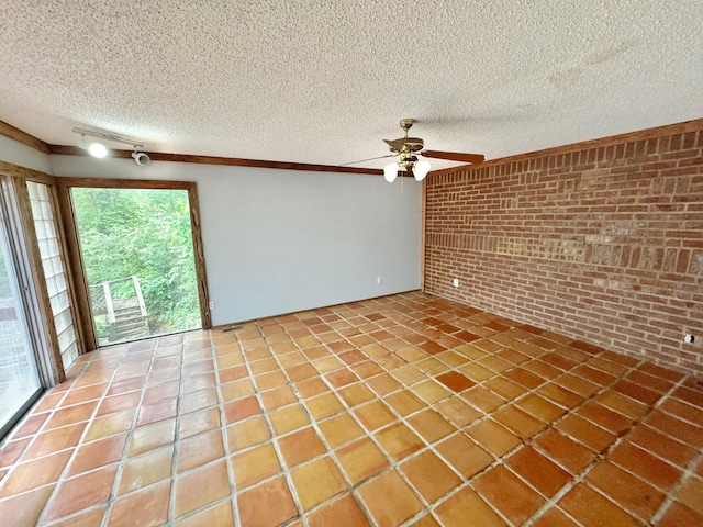 3751 Lakewood Dr N, Memphis, TN 38128 - empty room with brick wall, plenty of natural light, ceiling fan, a textured ceiling, and light tile patterned flooring