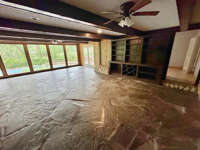 3751 Lakewood Dr N, Memphis, TN 38128 - unfurnished living room with ceiling fan, stone flooring, and a textured ceiling