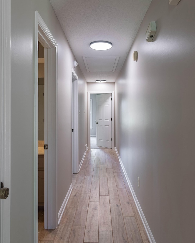 8432 Wood Shadows Ln, Memphis, TN 38018 - hall with attic access, light wood-style flooring, and baseboards