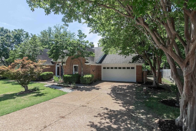 8432 Wood Shadows Ln, Memphis, TN 38018 - view of property hidden behind natural elements featuring brick siding, a garage, concrete driveway, and roof with shingles