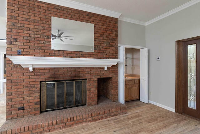 8432 Wood Shadows Ln, Memphis, TN 38018 - unfurnished living room with a brick fireplace, a ceiling fan, ornamental molding, baseboards, and light wood-style floors