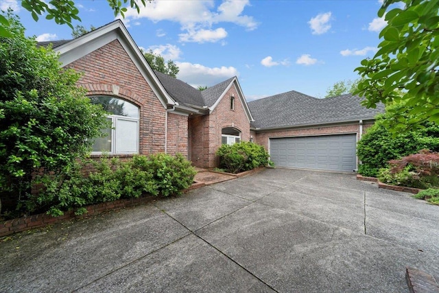 3559 Windgarden Cv, Memphis, TN 38125 - view of front of house with brick siding, an attached garage, driveway, and roof with shingles