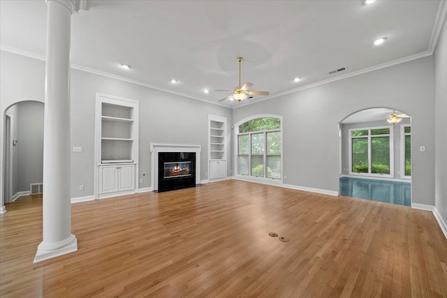 3559 Windgarden Cv, Memphis, TN 38125 - unfurnished living room with arched walkways, decorative columns, built in features, a ceiling fan, and light wood finished floors
