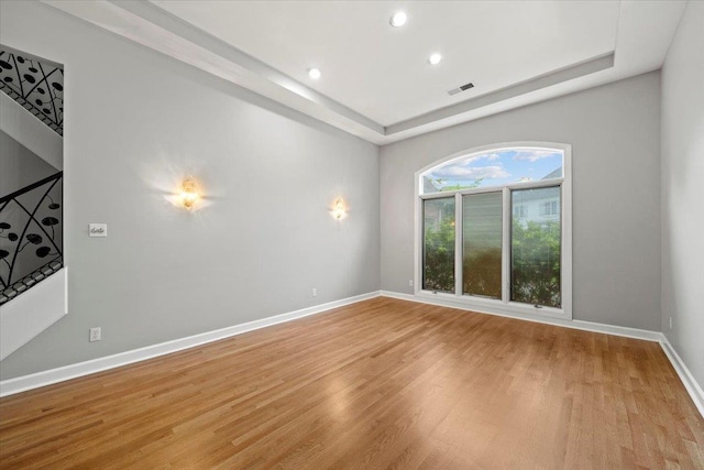 3559 Windgarden Cv, Memphis, TN 38125 - empty room with light wood finished floors, baseboards, a raised ceiling, and recessed lighting