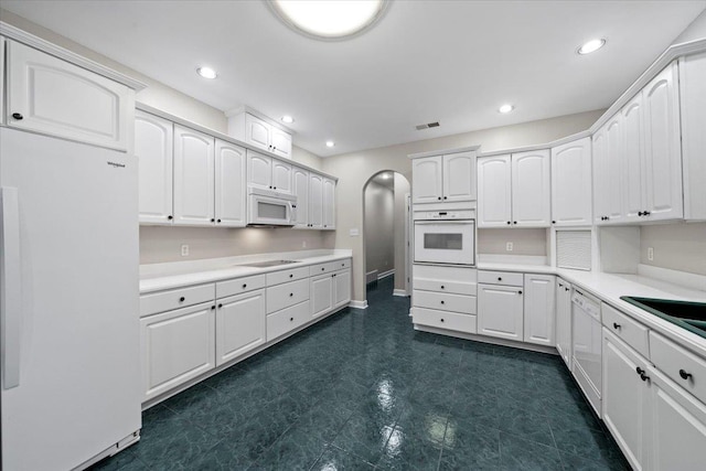 3559 Windgarden Cv, Memphis, TN 38125 - kitchen featuring white appliances, white cabinetry, light countertops, and recessed lighting