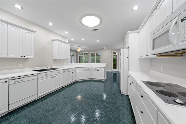 3559 Windgarden Cv, Memphis, TN 38125 - kitchen with white appliances, a sink, a peninsula, white cabinets, and light countertops