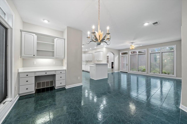 3559 Windgarden Cv, Memphis, TN 38125 - kitchen featuring baseboards, arched walkways, open shelves, a ceiling fan, and a chandelier