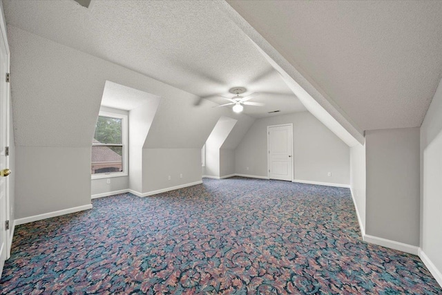 3559 Windgarden Cv, Memphis, TN 38125 - additional living space featuring a textured ceiling, carpet flooring, a ceiling fan, baseboards, and lofted ceiling