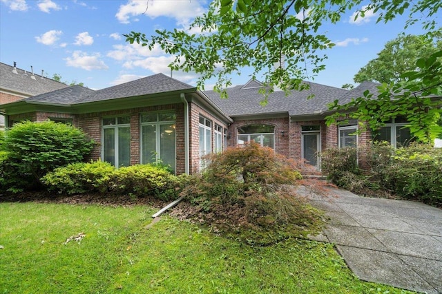 3559 Windgarden Cv, Memphis, TN 38125 - view of front of house featuring brick siding, a shingled roof, and a front lawn
