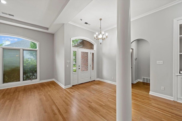 3559 Windgarden Cv, Memphis, TN 38125 - foyer entrance featuring arched walkways, light wood-type flooring, baseboards, a chandelier, and ornamental molding