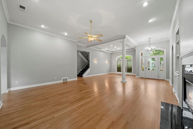 3559 Windgarden Cv, Memphis, TN 38125 - unfurnished living room with decorative columns, a glass covered fireplace, recessed lighting, stairway, and light wood-style floors