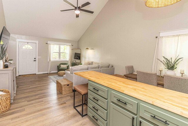 220 Harrison Rd, Michie, TN 38357 - living room featuring a ceiling fan, light wood-style flooring, high vaulted ceiling, and baseboards