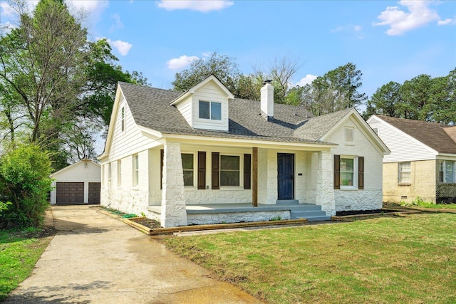 2551 Union Ave, Memphis, TN 38112 - view of front of house featuring a chimney, an outbuilding, a garage, a front lawn, and stone siding