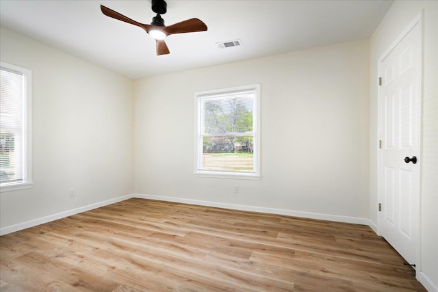 2551 Union Ave, Memphis, TN 38112 - unfurnished bedroom with multiple windows, light wood-style floors, and baseboards