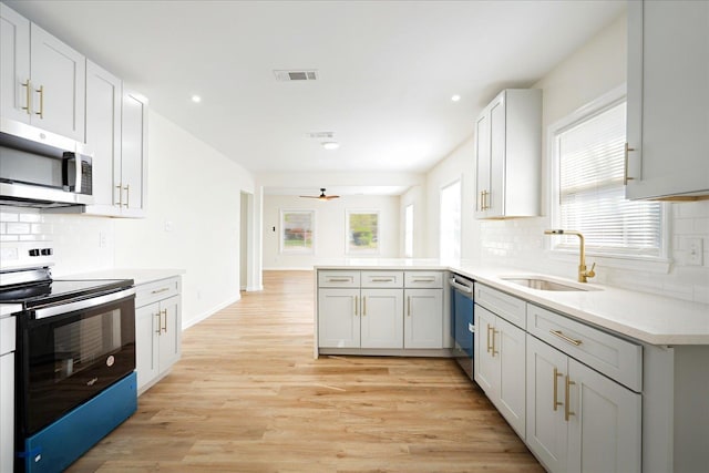 2551 Union Ave, Memphis, TN 38112 - kitchen with stainless steel appliances, a sink, a peninsula, recessed lighting, and ceiling fan