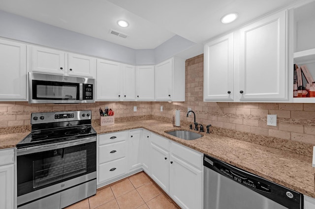 1822 Dragonfly Cv Unit 79, Germantown, TN 38138 - kitchen featuring stainless steel appliances, a sink, white cabinets, tasteful backsplash, and light tile patterned floors