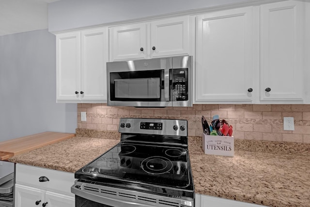 1822 Dragonfly Cv Unit 79, Germantown, TN 38138 - kitchen with stainless steel appliances, white cabinetry, and decorative backsplash