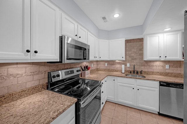 1822 Dragonfly Cv Unit 79, Germantown, TN 38138 - kitchen with appliances with stainless steel finishes, a sink, light tile patterned flooring, and white cabinets