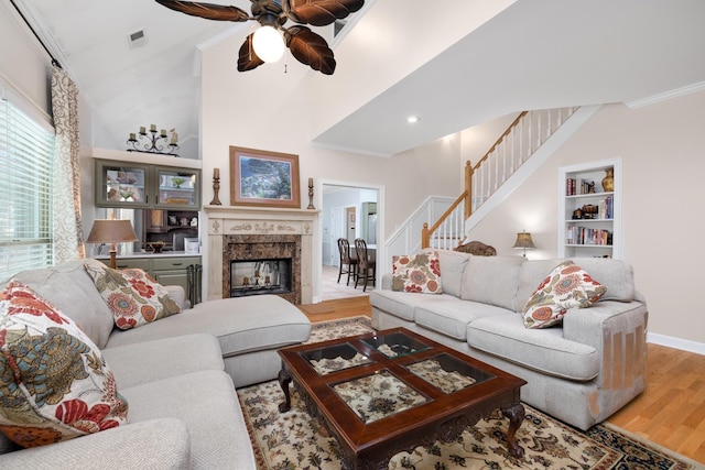 1620 Saddle Chase Cv, Memphis, TN 38016 - living area featuring wood finished floors, ceiling fan, stairs, crown molding, and a multi sided fireplace