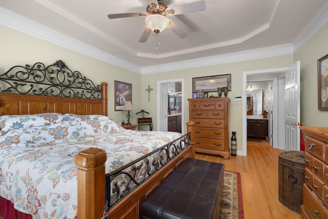 1620 Saddle Chase Cv, Memphis, TN 38016 - bedroom with a tray ceiling, light wood-style floors, ensuite bathroom, ceiling fan, and crown molding