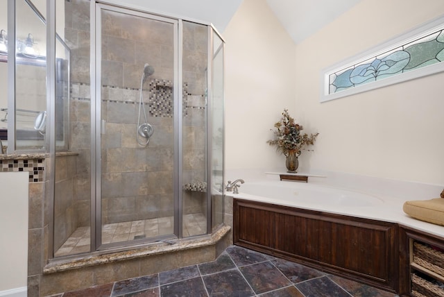 1620 Saddle Chase Cv, Memphis, TN 38016 - full bathroom featuring a bath, a shower stall, stone finish floors, and vaulted ceiling
