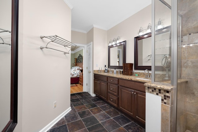 1620 Saddle Chase Cv, Memphis, TN 38016 - ensuite bathroom with double vanity, crown molding, stone finish flooring, a shower stall, and baseboards