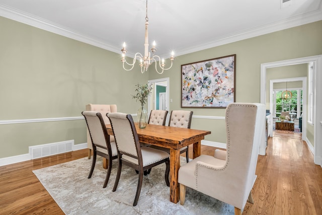 99 Red Acres Pl, Memphis, TN 38111 - dining space featuring a chandelier, ornamental molding, wood finished floors, and baseboards