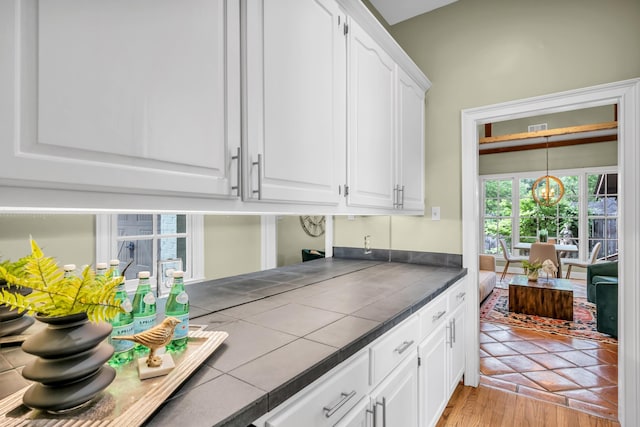 99 Red Acres Pl, Memphis, TN 38111 - kitchen with white cabinets, tile counters, a chandelier, and light wood-type flooring
