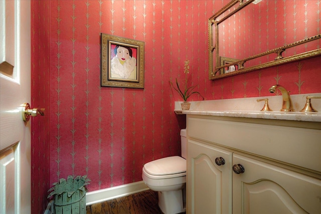 5239 Hedgewyck Ct, Memphis, TN 38117 - half bath with vanity, wood finished floors, toilet, and baseboards