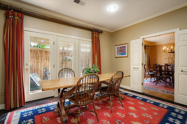 5239 Hedgewyck Ct, Memphis, TN 38117 - dining area with baseboards, crown molding, a chandelier, and wood finished floors