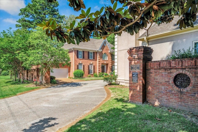 5239 Hedgewyck Ct, Memphis, TN 38117 - view of front of home featuring asphalt driveway, stucco siding, a front lawn, and brick siding