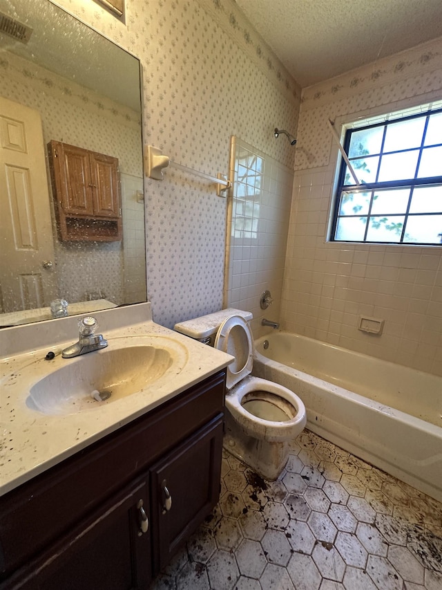 4378 Donnegan Cv, Memphis, TN 38125 - bathroom featuring vanity, washtub / shower combination, toilet, tile patterned floors, and wallpapered walls
