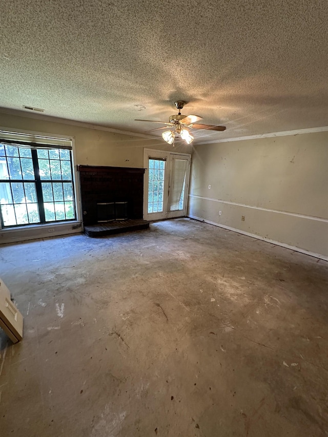4378 Donnegan Cv, Memphis, TN 38125 - unfurnished living room with unfinished concrete flooring, a textured ceiling, a fireplace with raised hearth, and ceiling fan