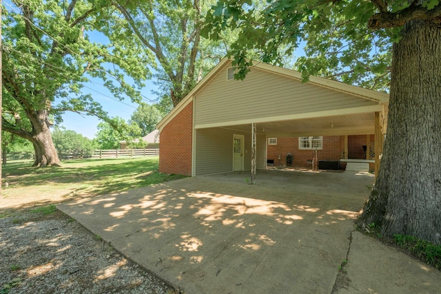 630 Raleigh-Lagrange Dr, Rossville, TN 38066 - back of property with concrete driveway, a carport, and brick siding