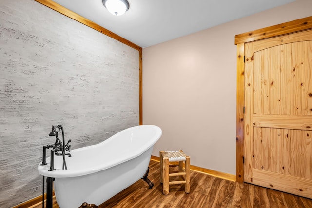 630 Raleigh-Lagrange Dr, Rossville, TN 38066 - full bath featuring wood finished floors, a freestanding bath, and baseboards