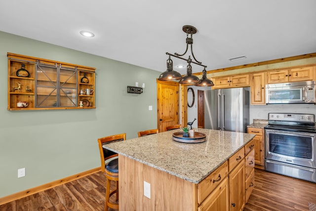 630 Raleigh-Lagrange Dr, Rossville, TN 38066 - kitchen featuring stainless steel appliances, dark wood finished floors, light stone countertops, a kitchen island, and baseboards
