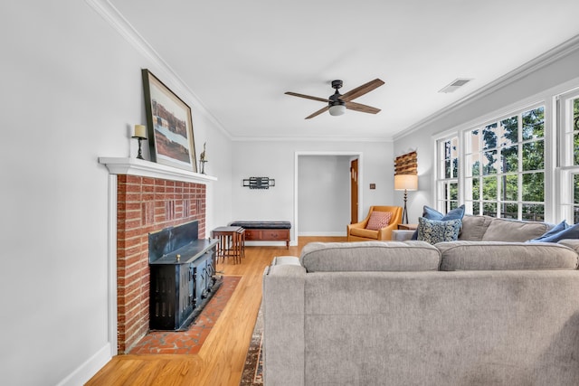 630 Raleigh-Lagrange Dr, Rossville, TN 38066 - living area featuring wood finished floors, ceiling fan, ornamental molding, baseboards, and a brick fireplace