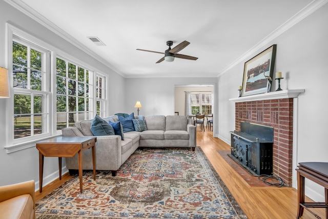 630 Raleigh-Lagrange Dr, Rossville, TN 38066 - living room featuring healthy amount of natural light, wood finished floors, ceiling fan, crown molding, and baseboards