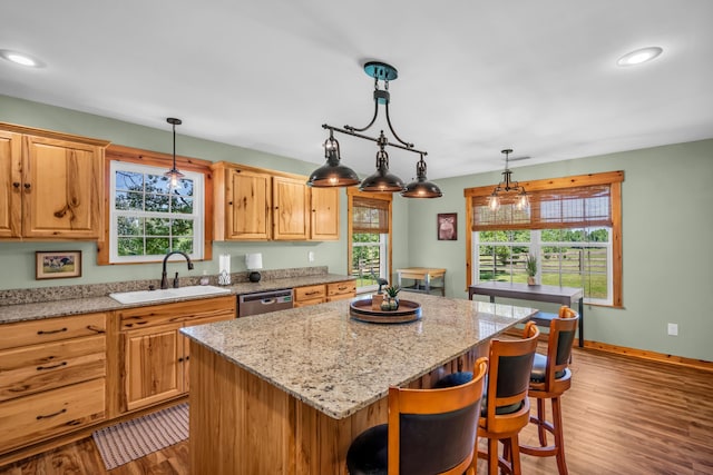 630 Raleigh-Lagrange Dr, Rossville, TN 38066 - kitchen with a sink, a center island, stainless steel dishwasher, wood finished floors, and a breakfast bar