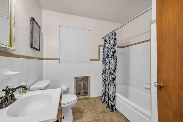 630 Raleigh-Lagrange Dr, Rossville, TN 38066 - full bath with heating unit, toilet, tile walls, shower / tub combo with curtain, and a textured ceiling